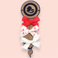 Upcycled Mayvis Mini bow set in Coral Swiss Dot series on kraft cardstock backing