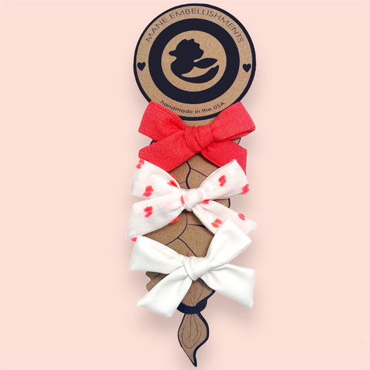 Upcycled Mayvis Mini bow set in Coral Swiss Dot series on kraft cardstock backing
